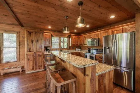 Above the Clouds cabin fully equipped kitchen with granite island and stainless steel appliances in Blue Ridge Georgia