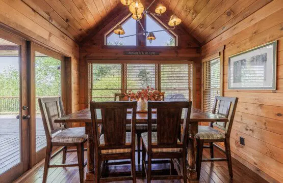 Above the Clouds cabin dining room with six person table and vaulted cedar ceiling in Blue Ridge Georgia