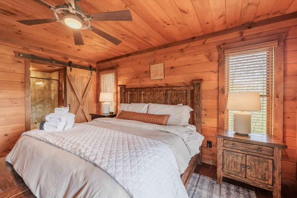 Above the Clouds cabin king bedroom with en suite barn door bathroom in Blue Ridge Georgia