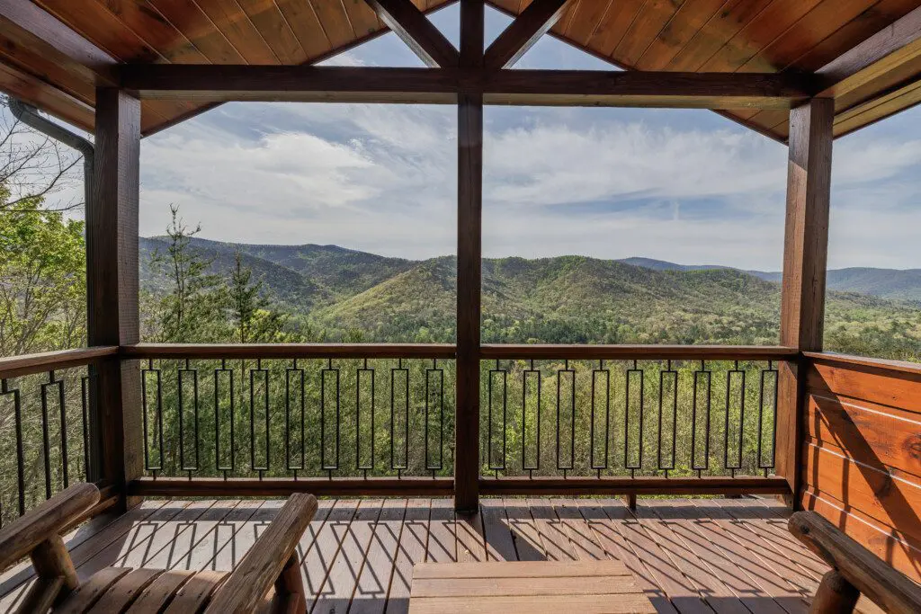 Above the Clouds cabin covered deck with panoramic North Georgia mountain views in Blue Ridge Georgia
