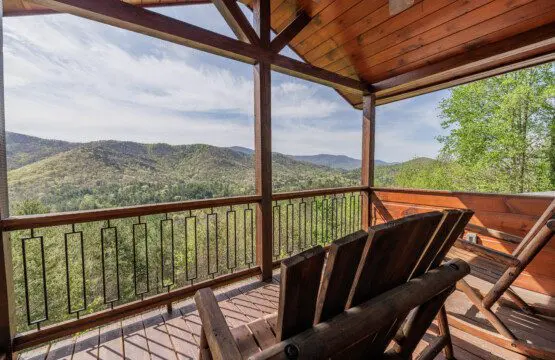 Above the Clouds cabin deck Adirondack chairs with layered North Georgia mountain views in Blue Ridge Georgia