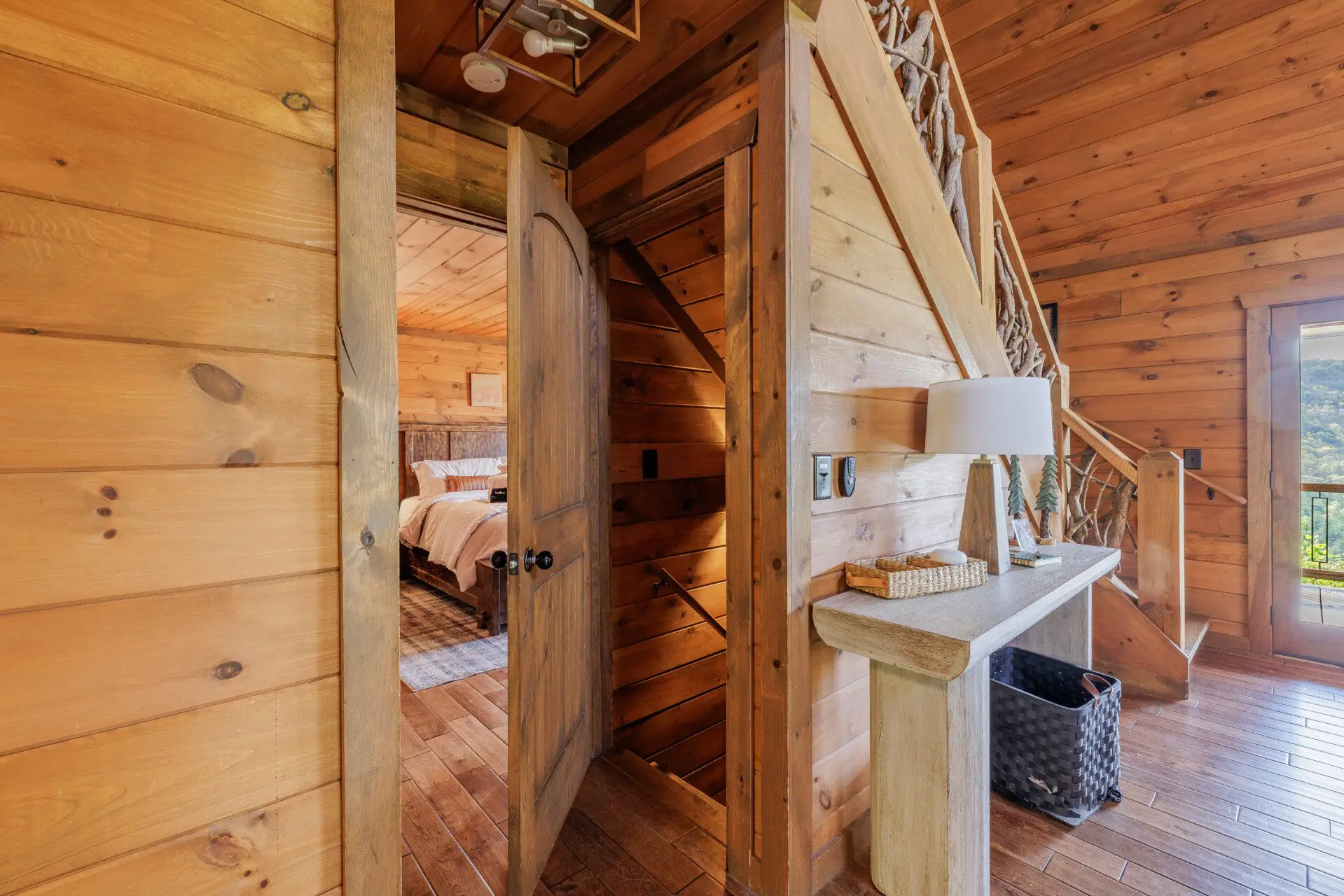 Above the Clouds cabin main floor hallway with antler staircase and bedroom entry in Blue Ridge Georgia