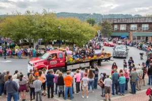 Crowds gather in downtown Ellijay, Georgia, to watch a colorful float in the Georgia Apple Festival parade.