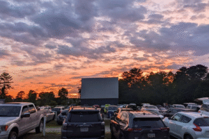 Cars parked at Swan Drive-In Theater in Blue Ridge, GA at sunset