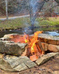 Stone firepit by the Ellijay River at River Run cabin rental in Blue Ridge, GA