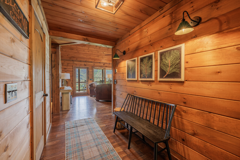 Above the Clouds cabin interior entryway hallway with cedar walls and mountain view in Blue Ridge Georgia