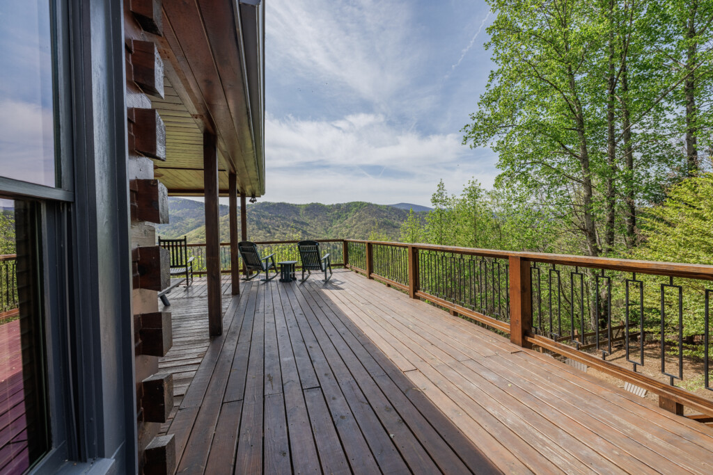 Above the Clouds cabin large wraparound deck with seating and expansive mountain views in Blue Ridge Georgia