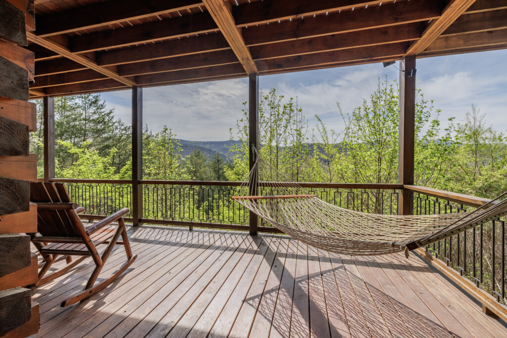 Above the Clouds cabin deck hammock with rocking chair and mountain views in Blue Ridge Georgia