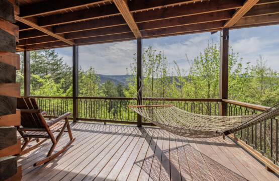 Above the Clouds cabin deck hammock with rocking chair and mountain views in Blue Ridge Georgia