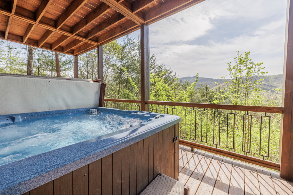 Above the Clouds cabin private hot tub on covered deck with North Georgia mountain views in Blue Ridge Georgia
