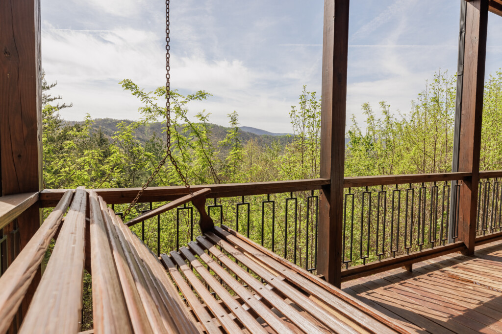 Above the Clouds cabin hanging porch swing bed with mountain views in Blue Ridge Georgia