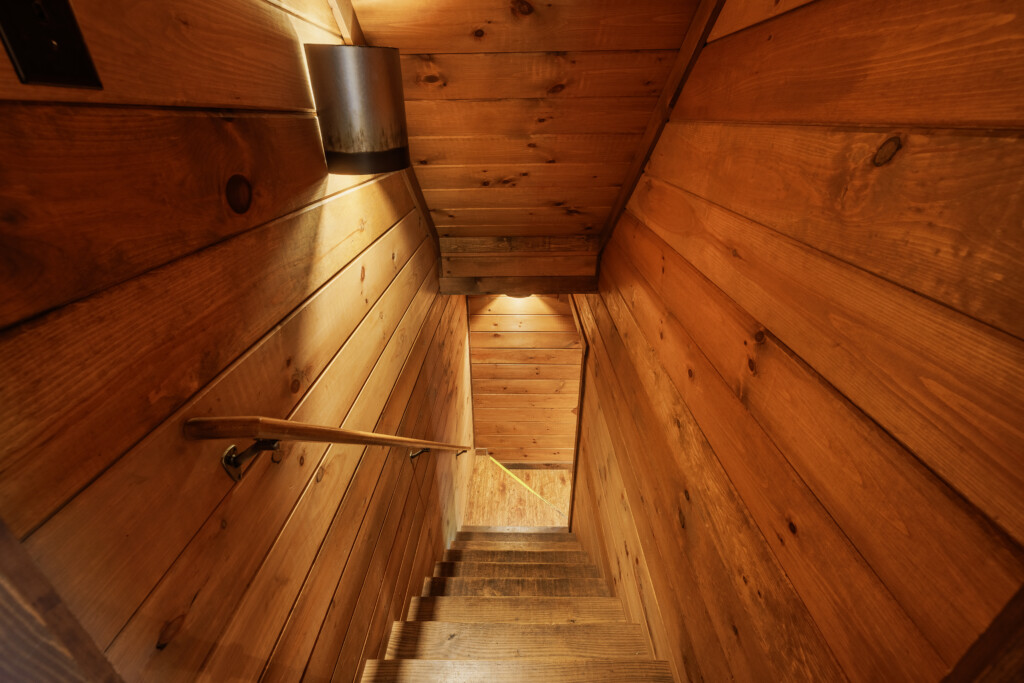 Above the Clouds cabin cedar staircase leading to lower level in Blue Ridge Georgia