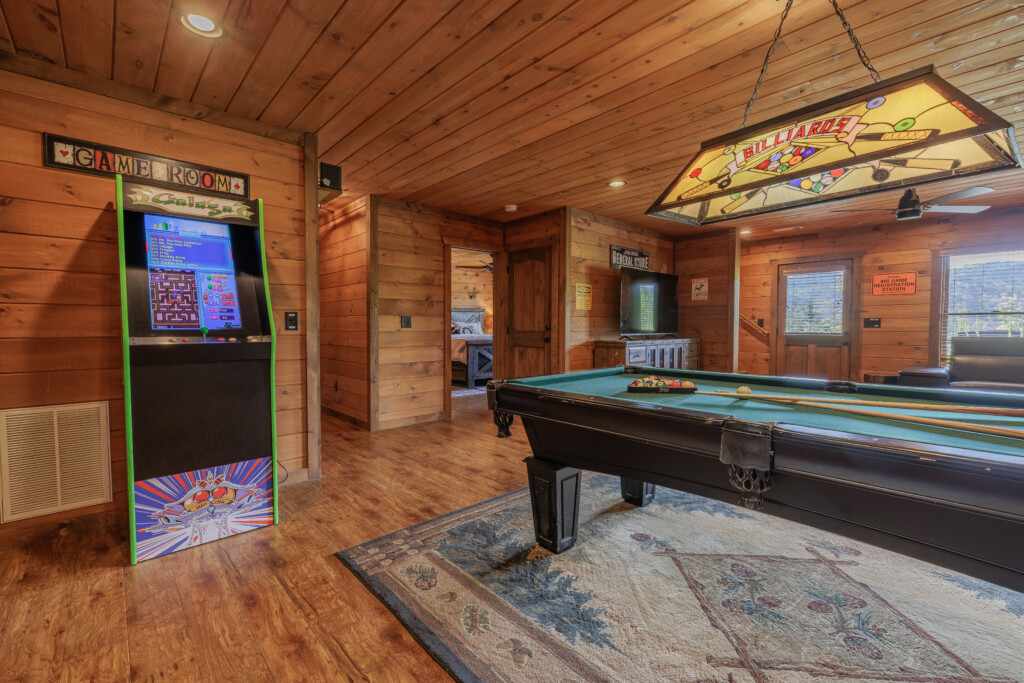 Above the Clouds cabin game room with Galaga arcade machine and billiards table in Blue Ridge Georgia