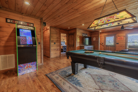 Above the Clouds cabin game room with Galaga arcade machine and billiards table in Blue Ridge Georgia