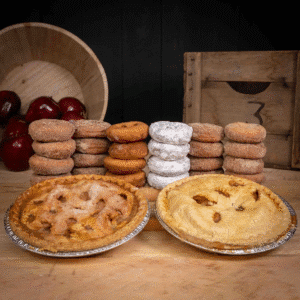 Freshly baked apple pies and stacks of cinnamon sugar and powdered sugar donuts from Mercier Orchards in Blue Ridge, Georgia — a must-try stop for Thanksgiving travelers.